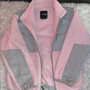 A pink and grey north face jacket